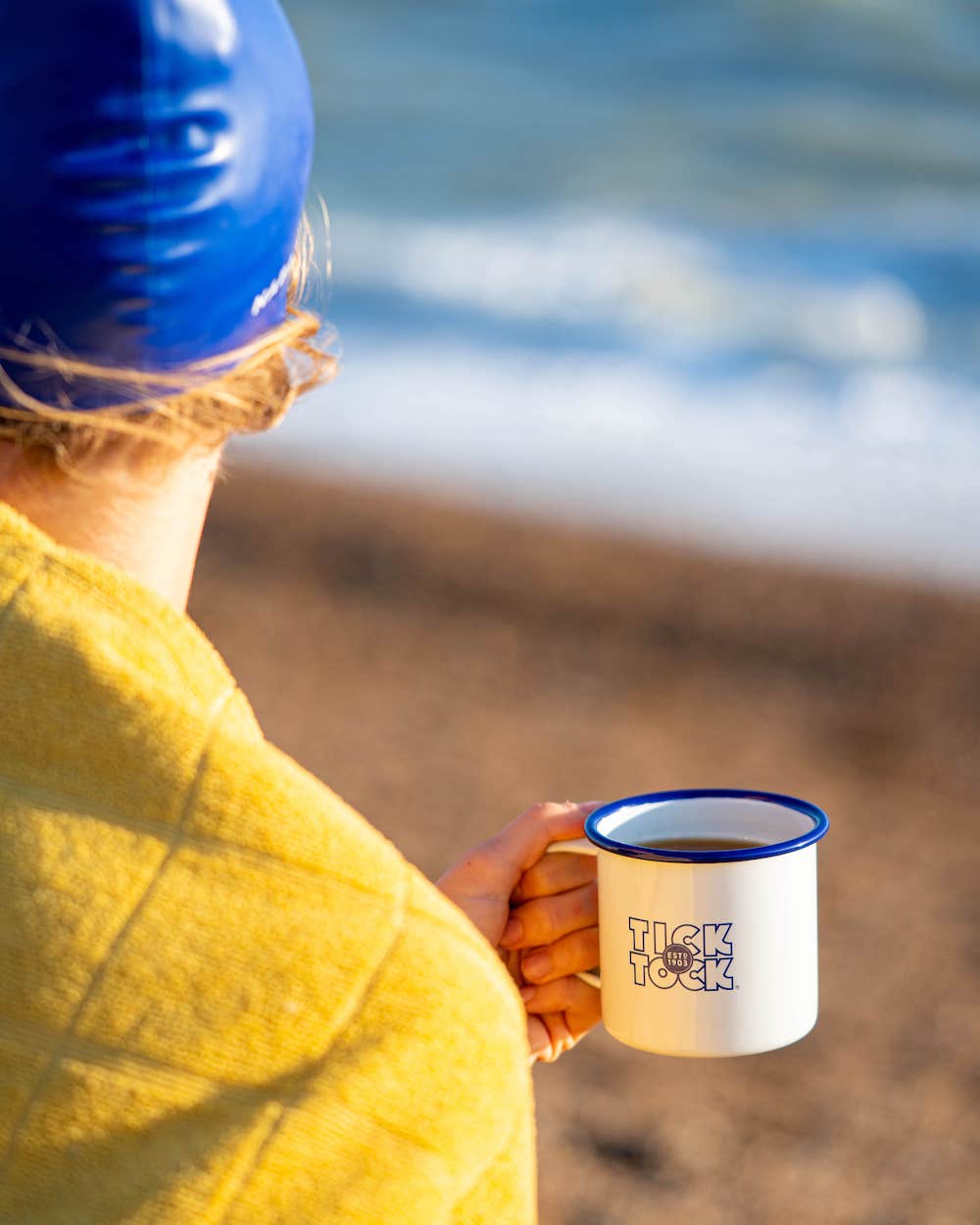 At the beach with a mug of tea