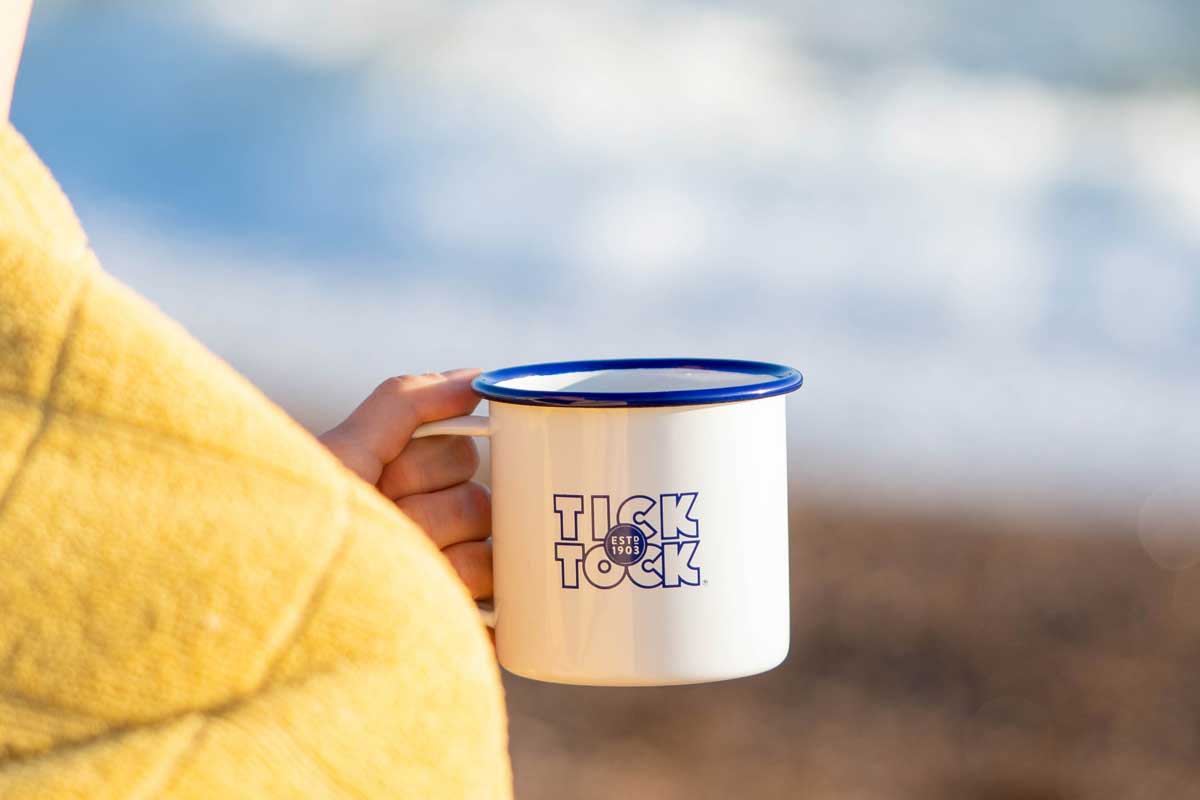 Enamel mug at the sea